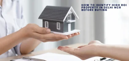 A person hands over a small model of a house to another person, symbolizing a real estate transaction, with the text 